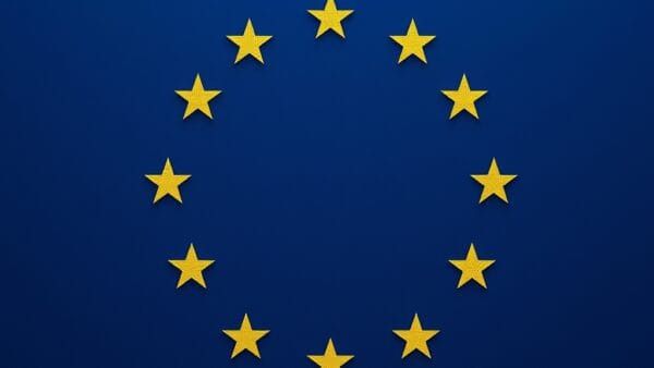 cinematic editorial dark navy blue legal document aesthetic, EU flag colors, AI-generated content icon symbol, marking labels, transparent layers, modern governance visual, no text no letters no words no writing no signs no labels no watermarks no logos no typography no numbers on surfaces