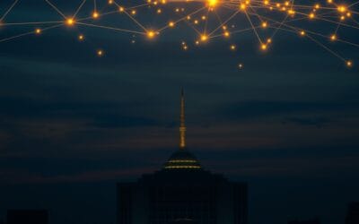 United Nations headquarters silhouette at dusk with glowing network nodes floating above, interconnected golden light streams across dark sky, diplomatic blue and gold color scheme, cinematic editorial photography, no text no letters no words no writing no signs no labels no watermarks no logos no typography no numbers on surfaces